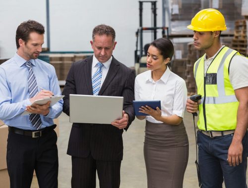 Focused warehouse team working together in a large warehouse